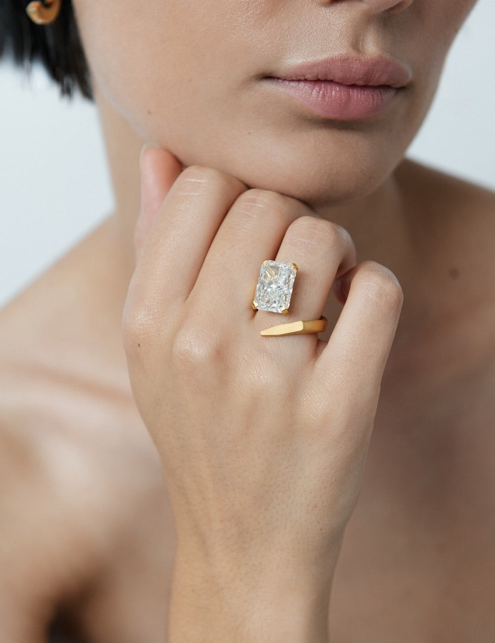 Ciufoli One sculptural asymmetric yellow gold ring with diamond on model