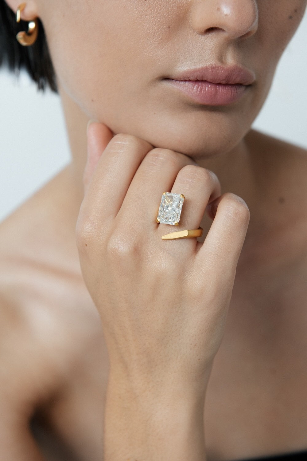 Ciufoli One sculptural asymmetric yellow gold ring with diamond on model