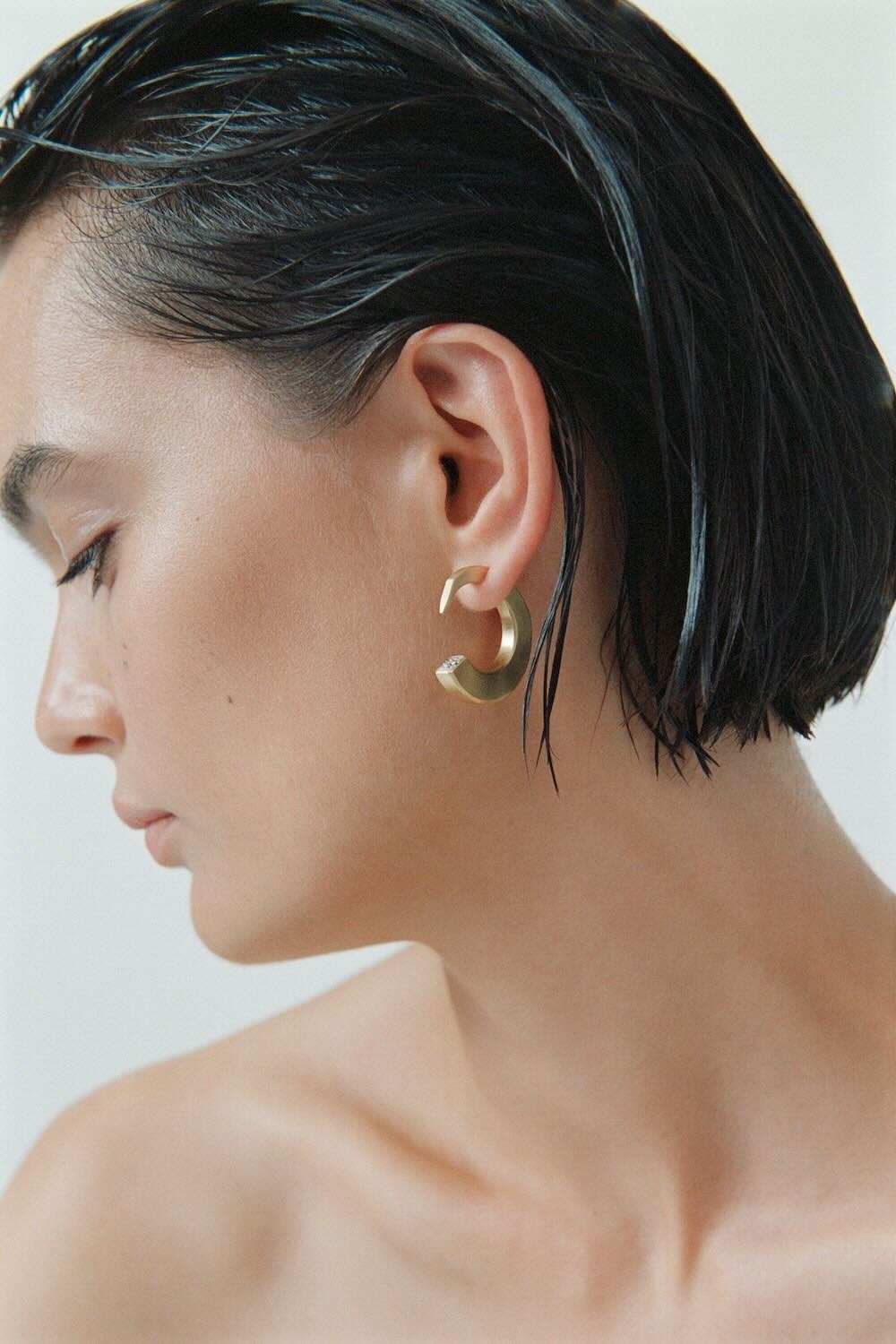 Ciufoli One sculptural medium yellow gold earrings with diamond on model